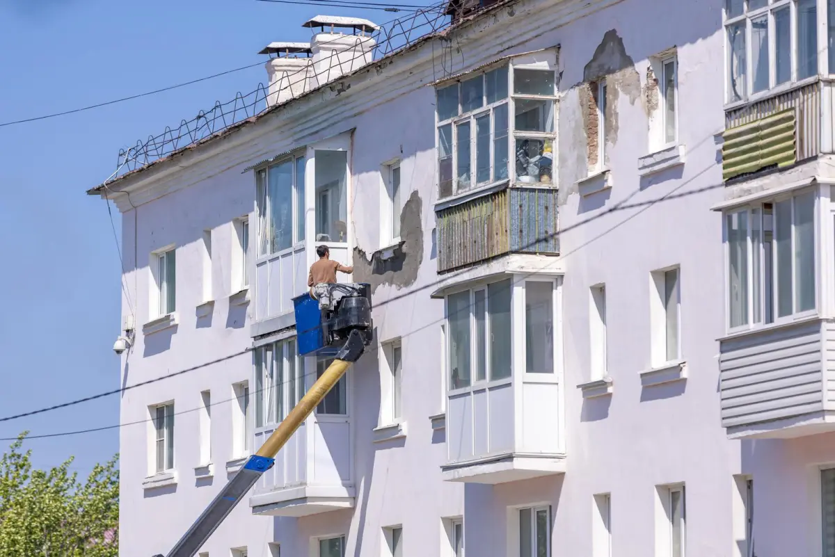 Rénovation d'une façade d'immeuble depuis une nacelle élévatrice